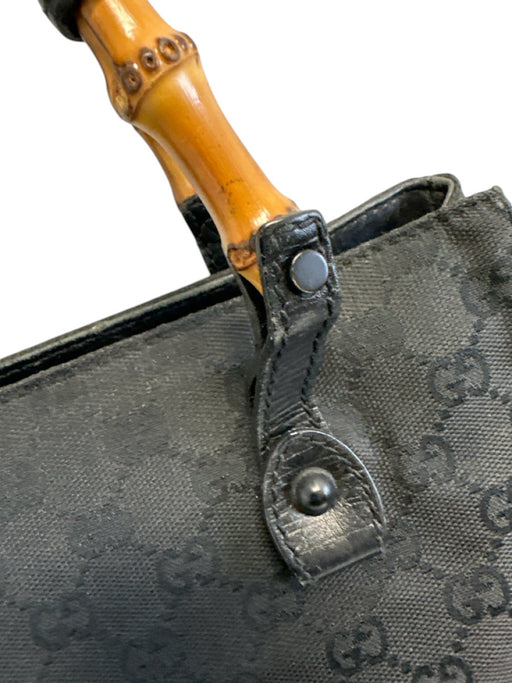 Labels Resale Boutique Gucci black Guccissima canvas bag featuring a distinctive bamboo handle and leather trim.
