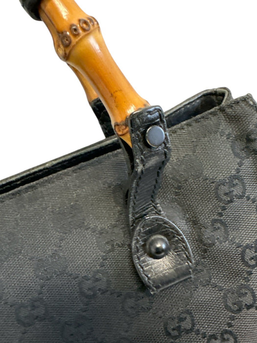 Labels Resale Boutique Gucci black Guccissima canvas bag featuring a distinctive bamboo handle and leather trim.